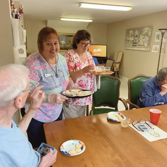 Staff members serving meals to seniors at Old Glory Days Adult Day Care in Sandy Hook, CT.